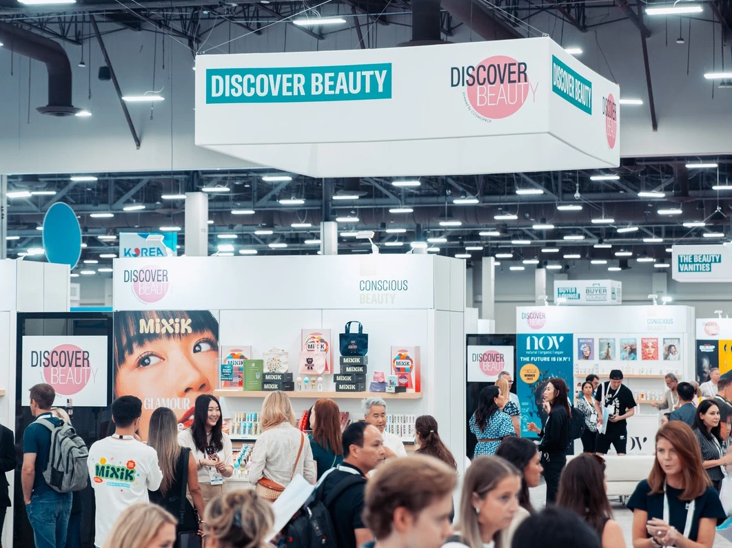 Beauty exhibitors and visitors at a trade show.